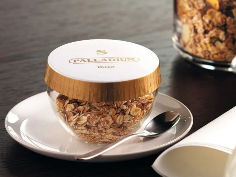 A branded glass cover on a breakfast bowl at Palladium Ibiza
