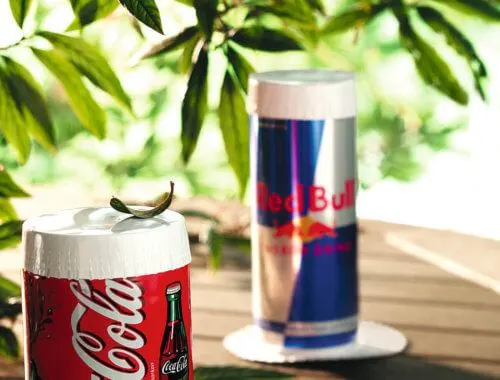 Paper covers on Coca-Cola and Red Bull cans outdoors