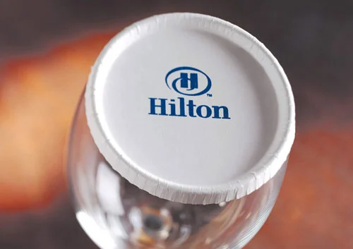 Short rim stancap on a wine glass with Hilton logo